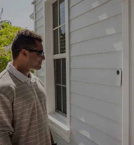 man looking at ADT doorbell camera